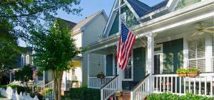house with vinyl siding and an American flg